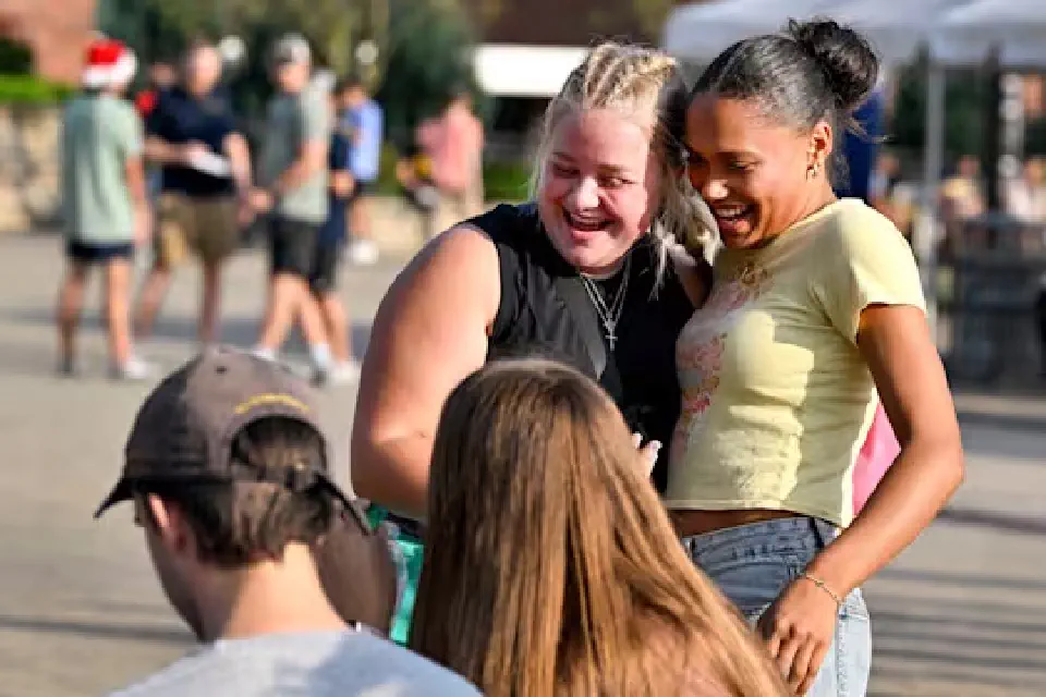 students hugging
